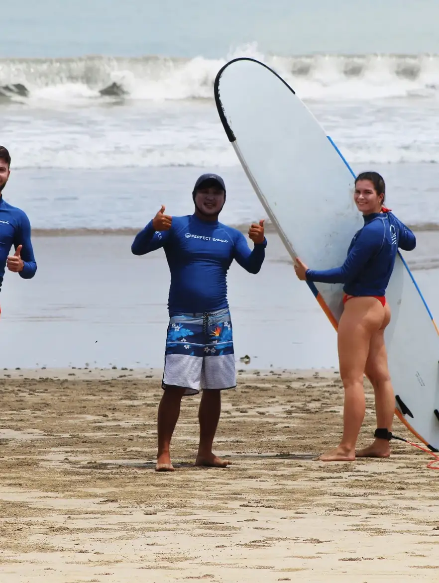 Justin Buu’lolo on a Bali beach with two surfers holding their boards after a session